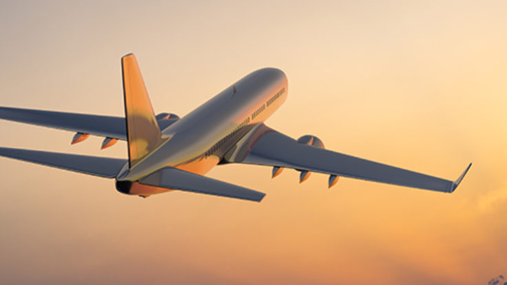 Passanger airplane flying above clouds in evening.